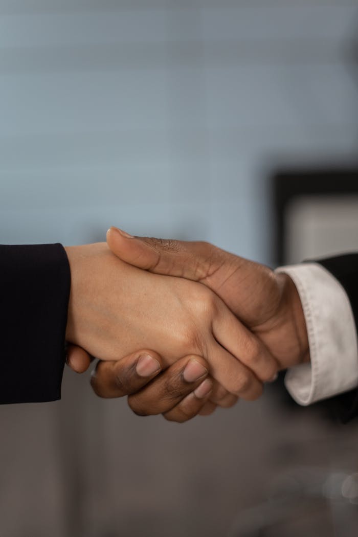 our-story Close-up of a professional handshake symbolizing business partnership and agreement.